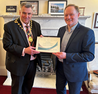 John McMaster receiving an Outstanding Achievement Award from Provost of Inverclyde Drew McKenzie.